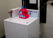 A washing machine with a bottle of liquid soap