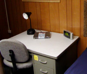 A desk with a litle lamp